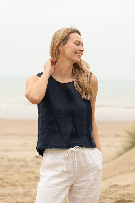 Model on beach laughing and looking to the side