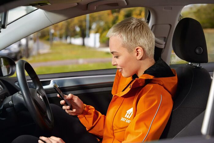 Girl in car texting on phone