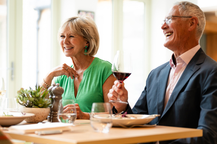 Classic model couple drinking wine and laughing together
