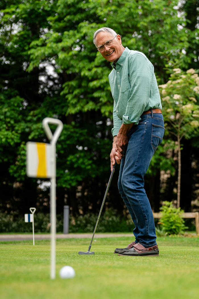 Gentleman playing mini golf