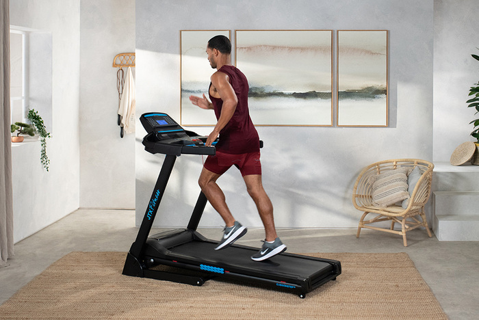 Male fitness model on treadmill
