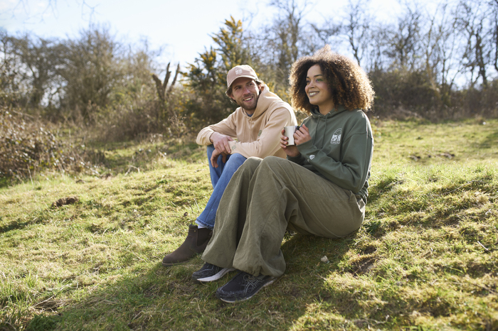 Couple sitting on grass laughing together