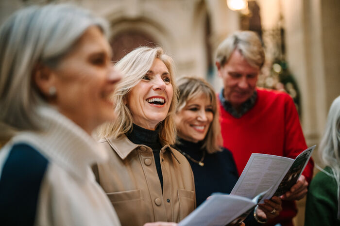 Group of friends singing carols together