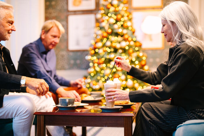 Group of friends at table drinking coffee together