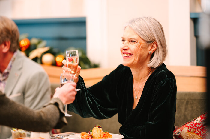 Female classic model smiling and drinking champagne