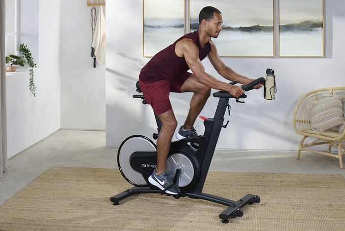 Male fitness model on exercise bike