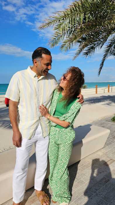 Model couple at beach looking at one another
