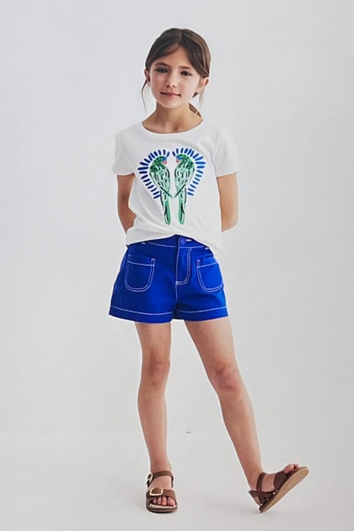 Junior model in shorts and graphic t shirt