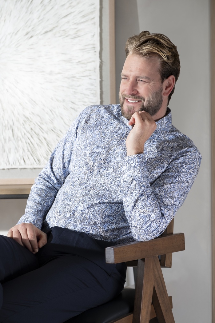 Male model smiling sitting down