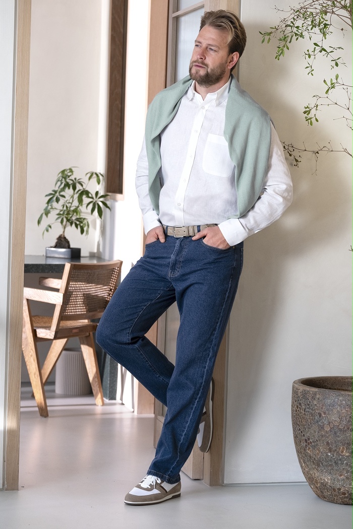 Male model leaning against wall