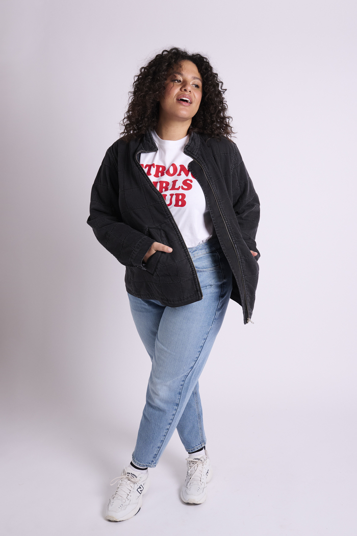 Curve model wearing blue jeans and black jacket