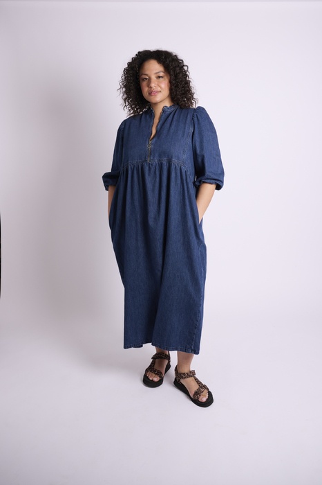 Curve model with cool expression in long denim dress