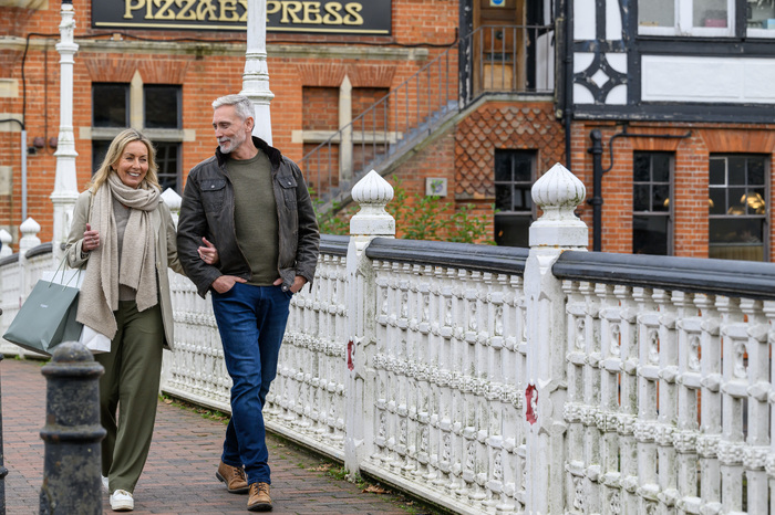 Couple walking arm in arm