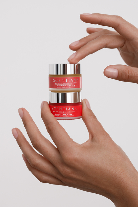 Hand model holding two beauty products