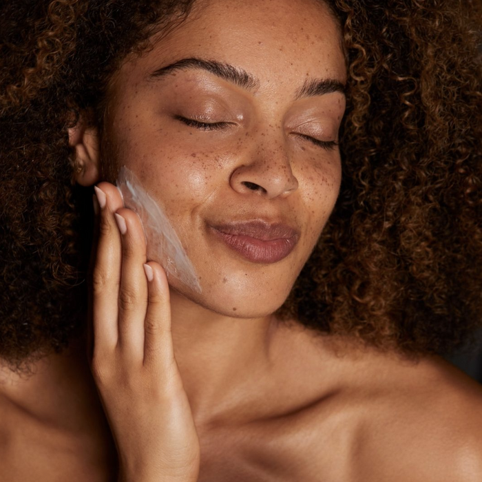 Model applying skin cream