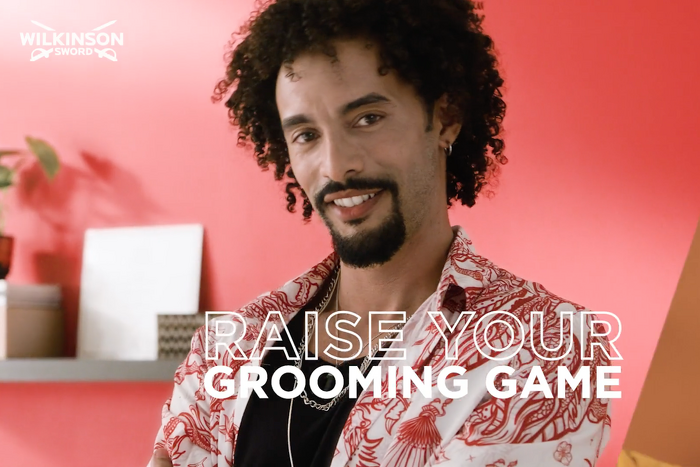 male model with beard smiling and the word raise your grooming game
