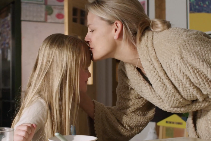 Mother kissing Daughter on the forehead