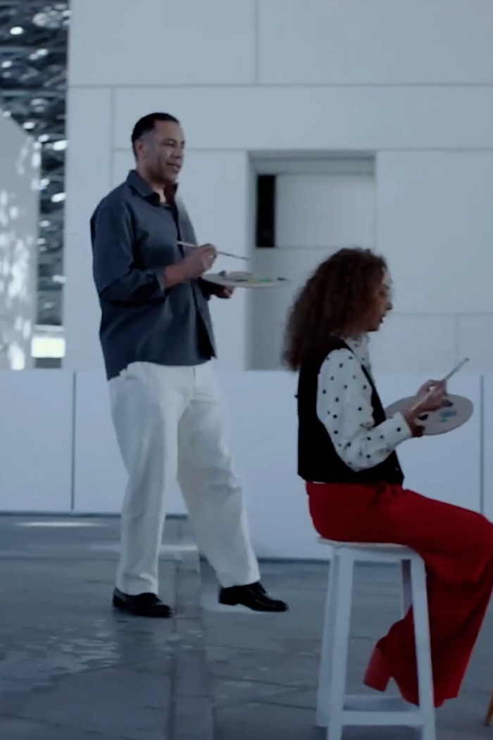 Male and female models painting a picture