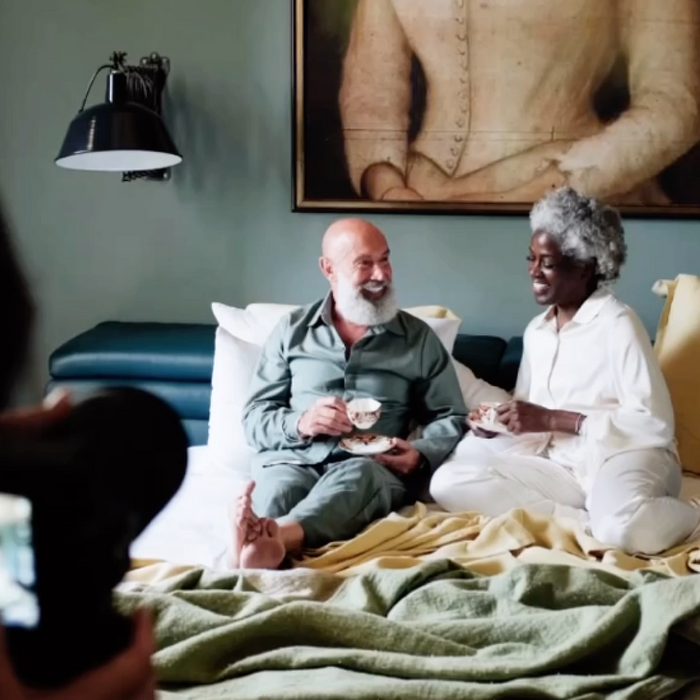 Classic model couple having breakfast in bed