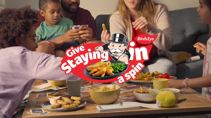 Family eating dinner and playing a board game