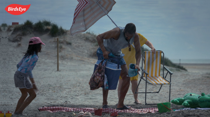 Family packing up as it rains on beach