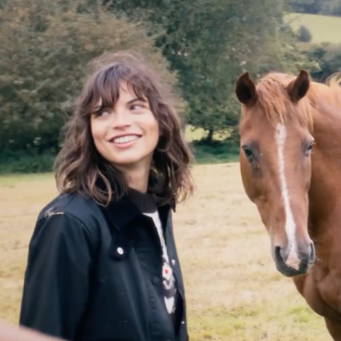 Female model smiling with horse