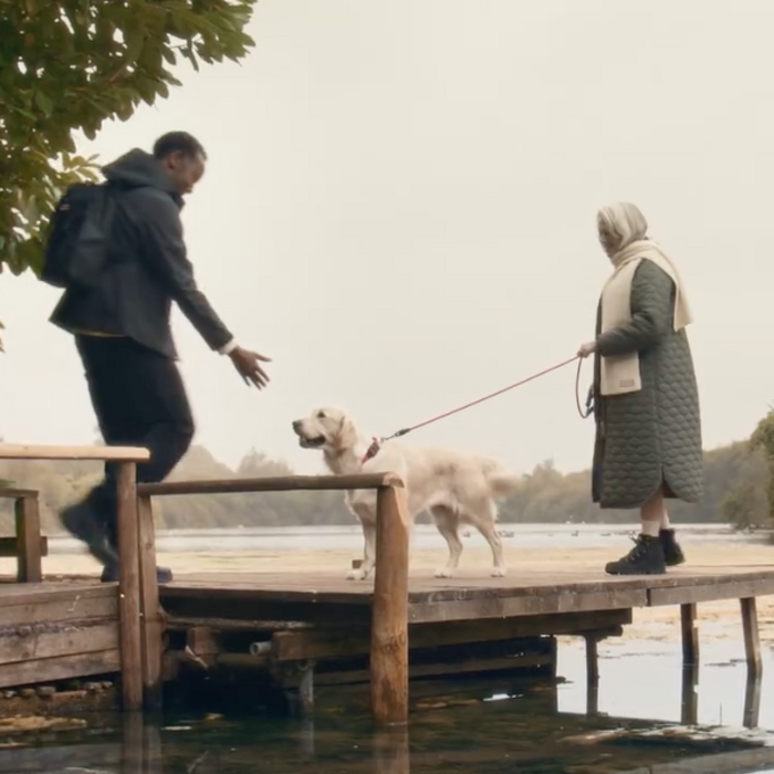 Two models walking a dog
