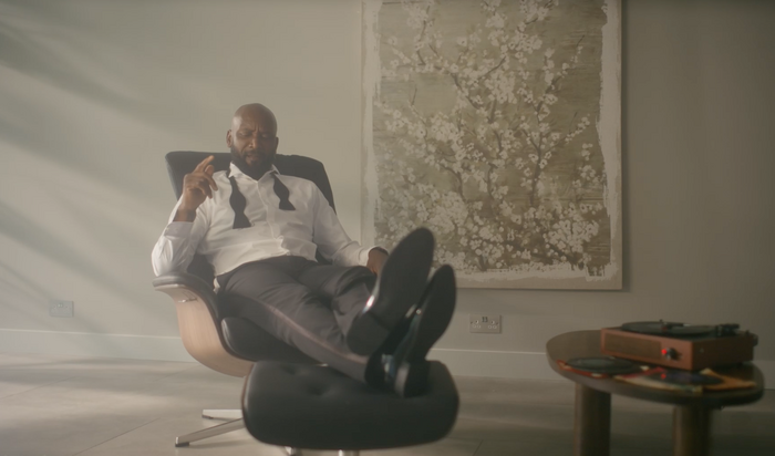 Man reclining in chair with feet on foot stool