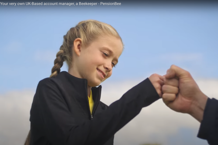 Junior female model smiling and fist bumping