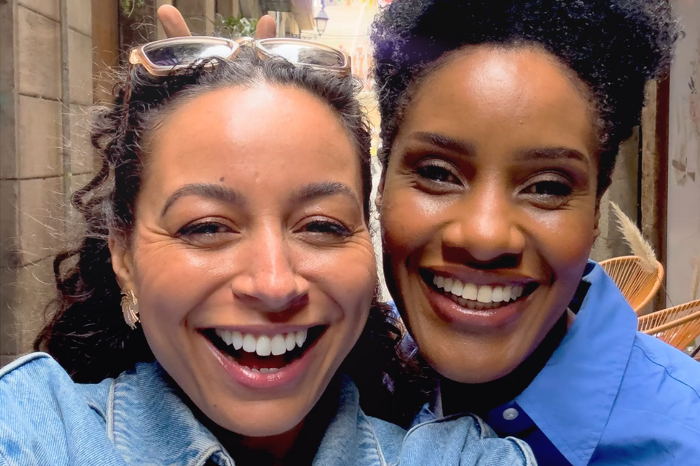 Two female friends laughing together