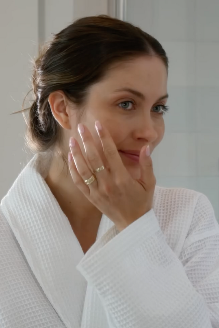 Female model applying face oil