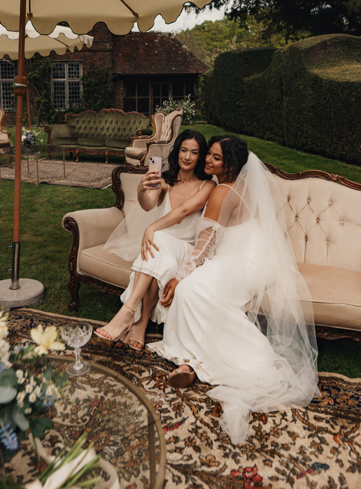 Two brides taking selfies