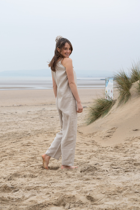 Model smiling looking over her shoulder on beach